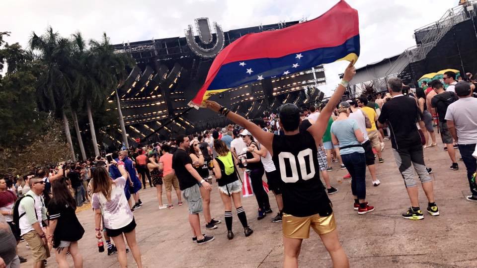 Alex Paredes from raannt.com dancing at the main stage of Ultra Music Festival Miami 2017 holding his Venezuelan Flag